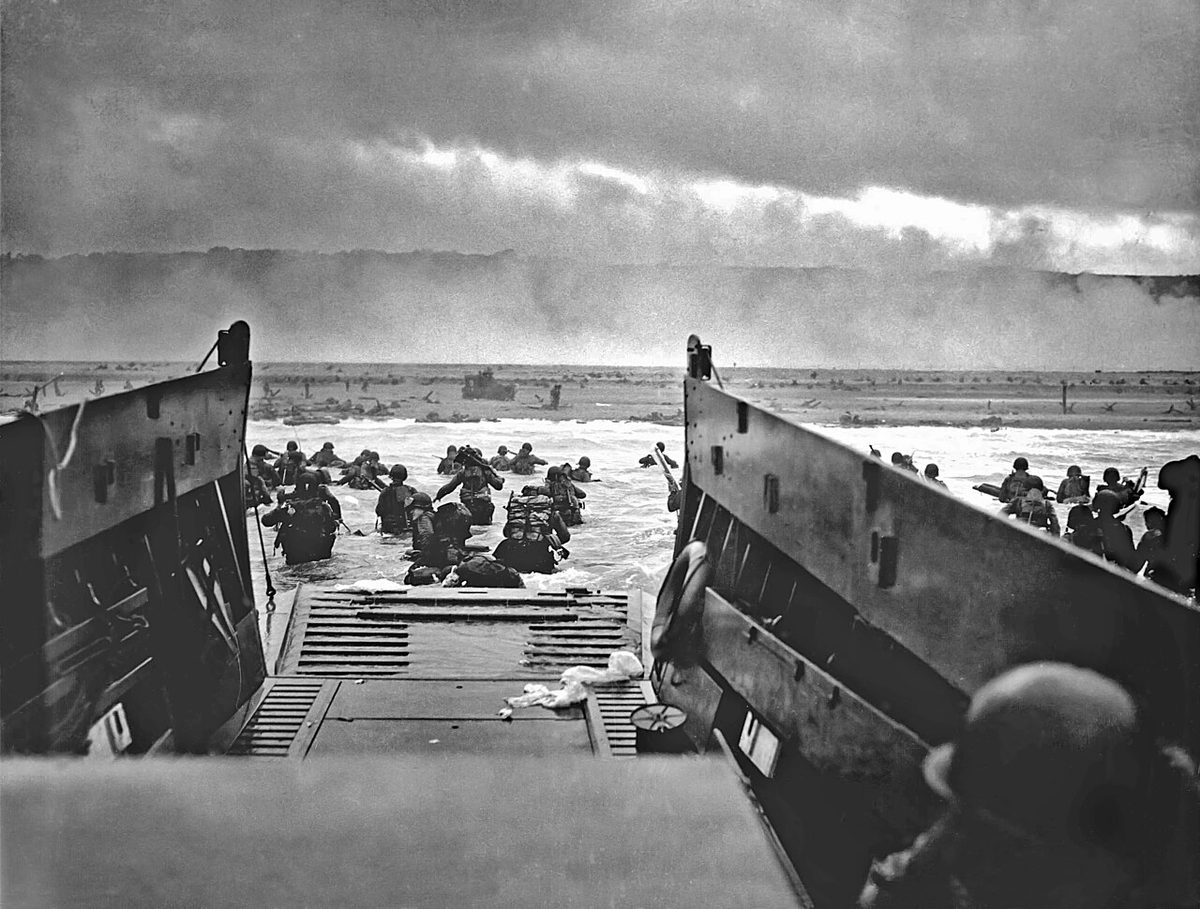 American troops wade from a landing craft toward Omaha Beach on 6 June 1944.