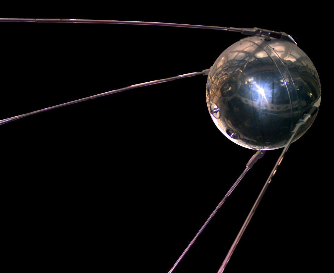A polished metal sphere with four long antennas: a replica of Sputnik 1.