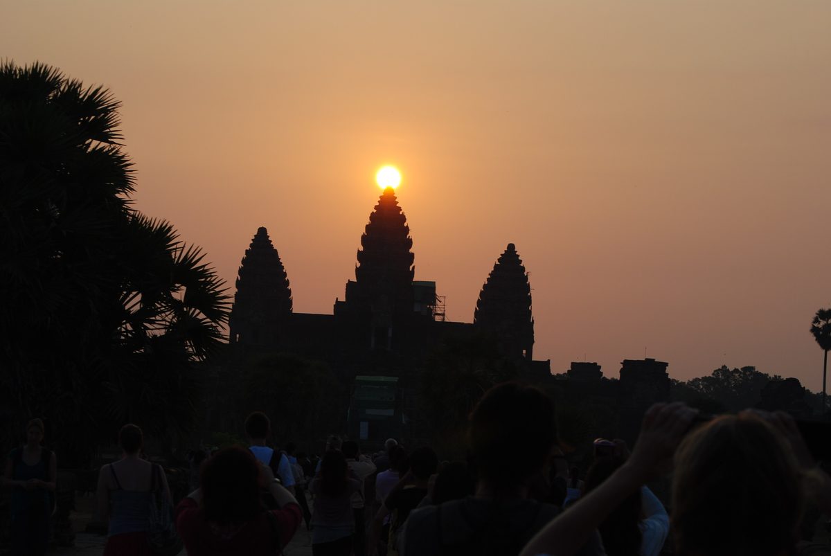 The Sun rises exactly over the central tower of Angkor Wat on the March equinox, watched by a crowd at the western entrance.