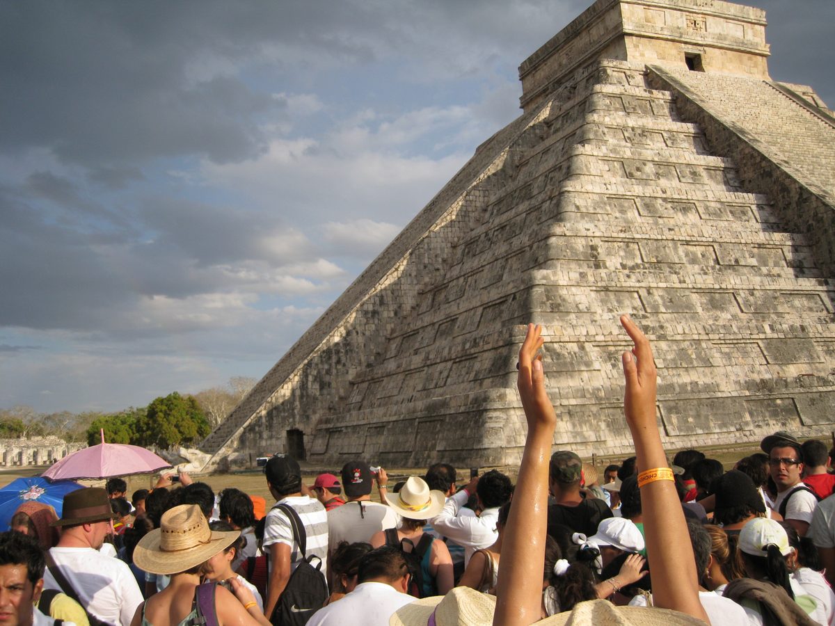 Crowds watch the serpent of light and shadow form down the staircase of El Castillo at Chichén Itzá on the spring equinox.