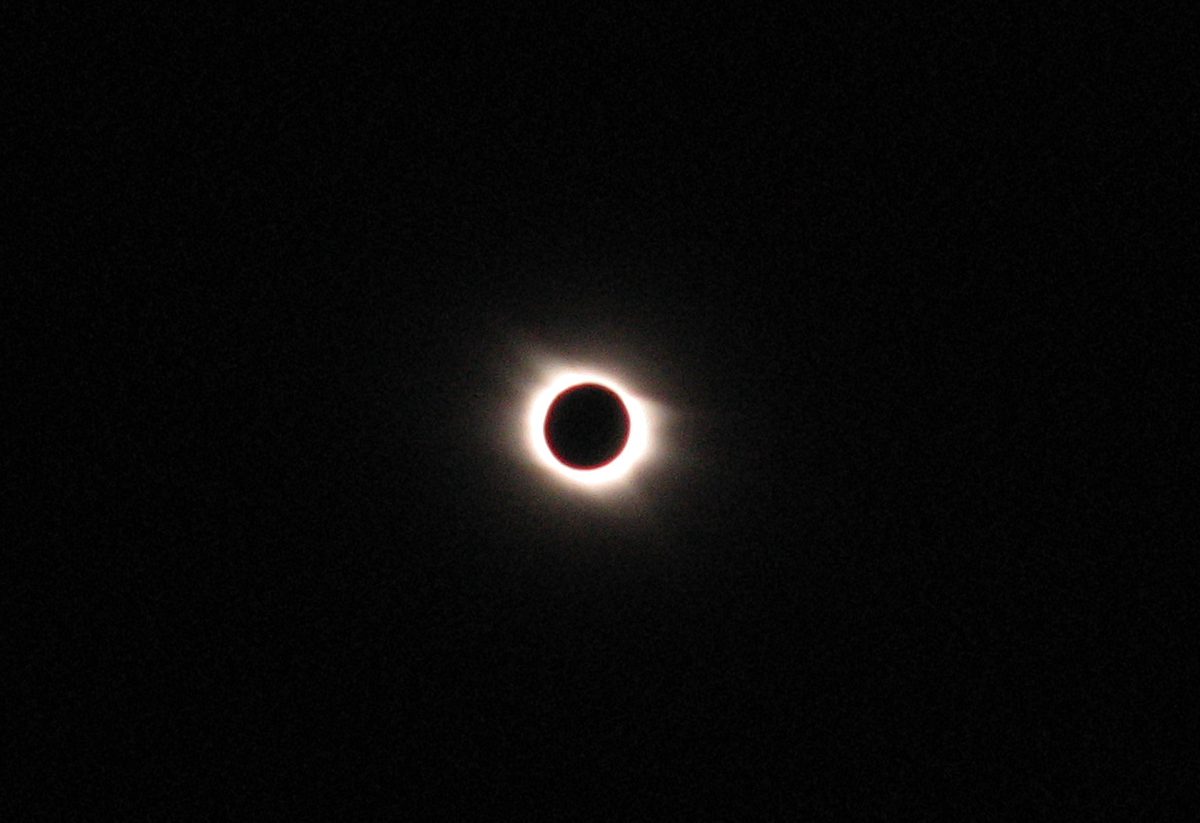 The Sun in total eclipse, a black disc ringed by the white corona, seen from Egypt in 2006.