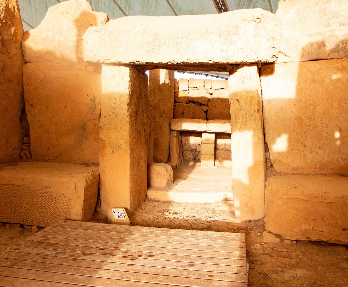 Equinox sunlight shines straight through the stone doorway into the inner chamber of the lower temple at Mnajdra.